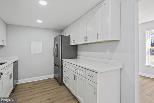 kitchen with stainless steel appliances, recessed lighting, white cabinets, light wood-type flooring, and baseboards