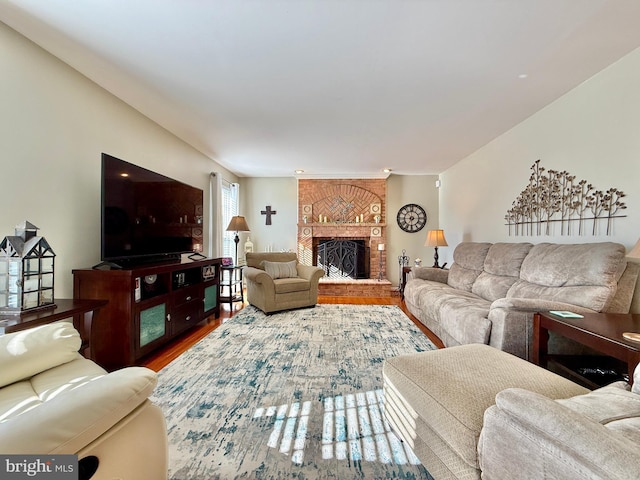 living room with a fireplace and wood finished floors