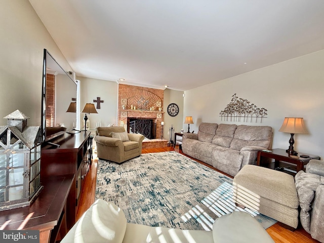 living room with a fireplace and wood finished floors