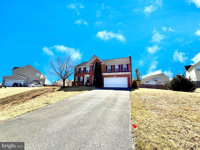 view of front of house featuring aphalt driveway and a garage