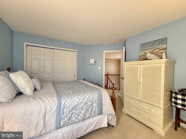 bedroom featuring a closet and light colored carpet