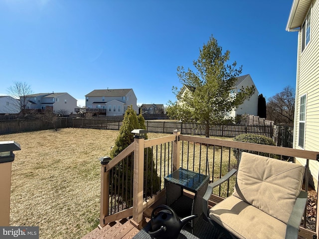 deck with a yard, a residential view, and a fenced backyard