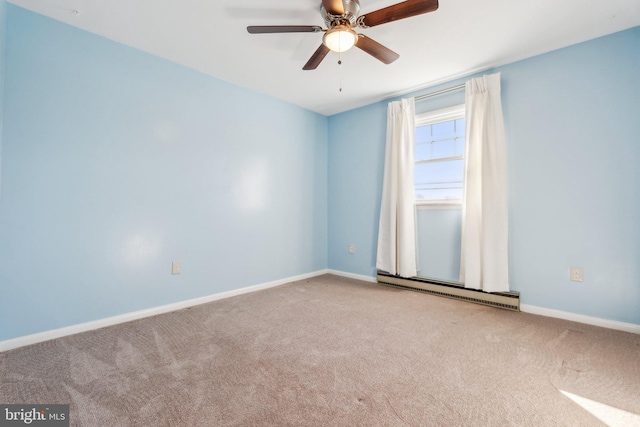 carpeted spare room featuring a baseboard radiator, baseboards, and ceiling fan