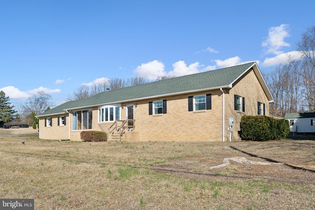 exterior space featuring a front yard and brick siding