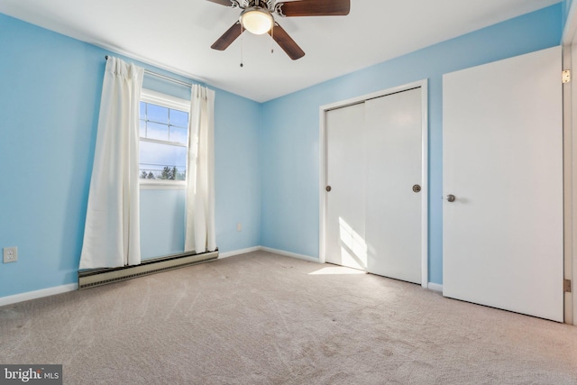 unfurnished bedroom featuring a closet, carpet flooring, baseboards, and a baseboard radiator