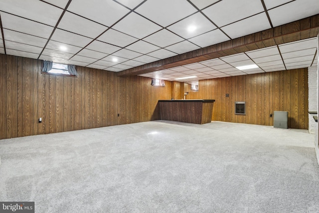 basement featuring wooden walls and carpet floors