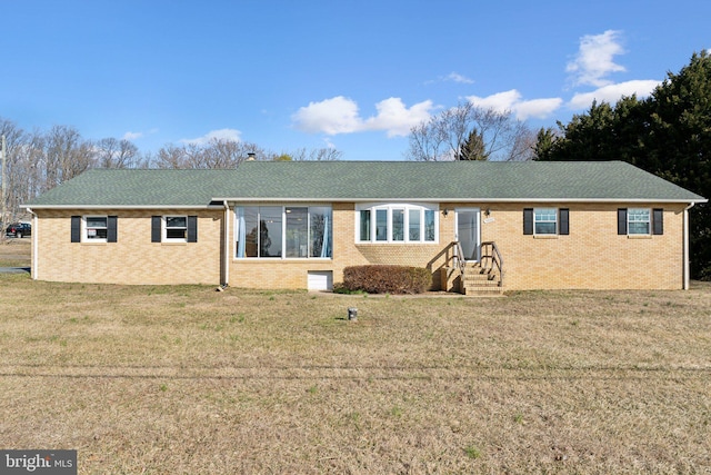 single story home with brick siding, entry steps, and a front lawn