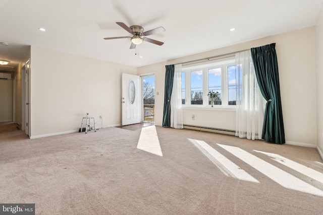 unfurnished living room with a wall unit AC, baseboards, carpet floors, recessed lighting, and ceiling fan