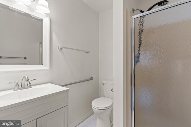 full bathroom with a stall shower, vanity, and toilet