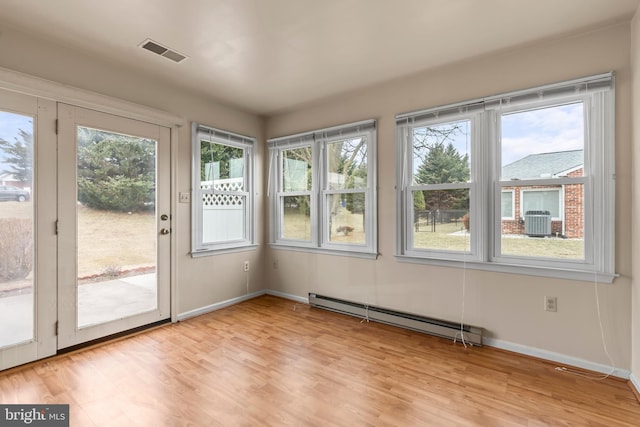 unfurnished sunroom with visible vents and baseboard heating