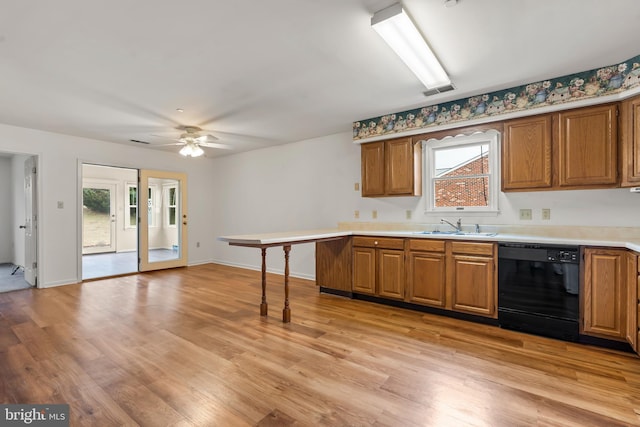 kitchen with brown cabinets, dishwasher, and a sink