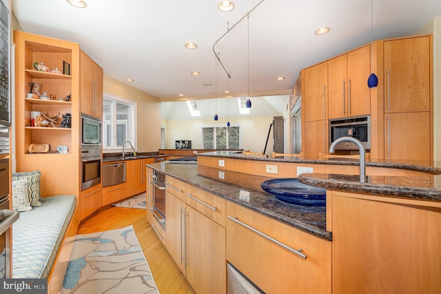 kitchen with open shelves, stainless steel appliances, recessed lighting, light wood-style flooring, and dark stone counters