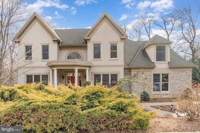 view of front of house with stone siding and stucco siding