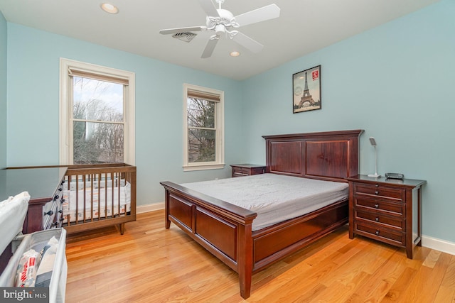 bedroom with baseboards, recessed lighting, visible vents, and light wood-style floors