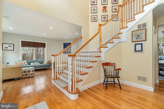 stairs featuring hardwood / wood-style flooring, baseboards, visible vents, and recessed lighting