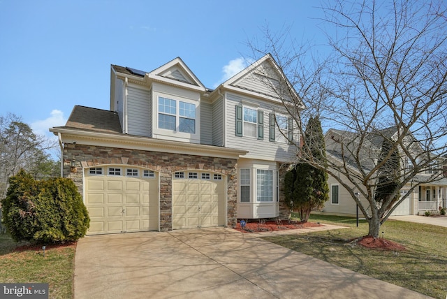 view of front of home with a garage, stone siding, and driveway