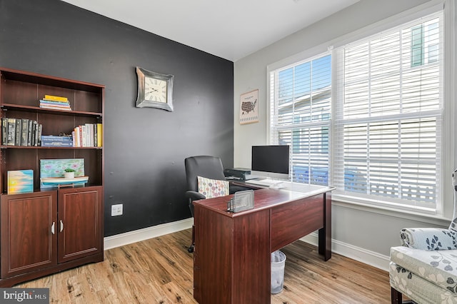 office space featuring baseboards and light wood-style floors