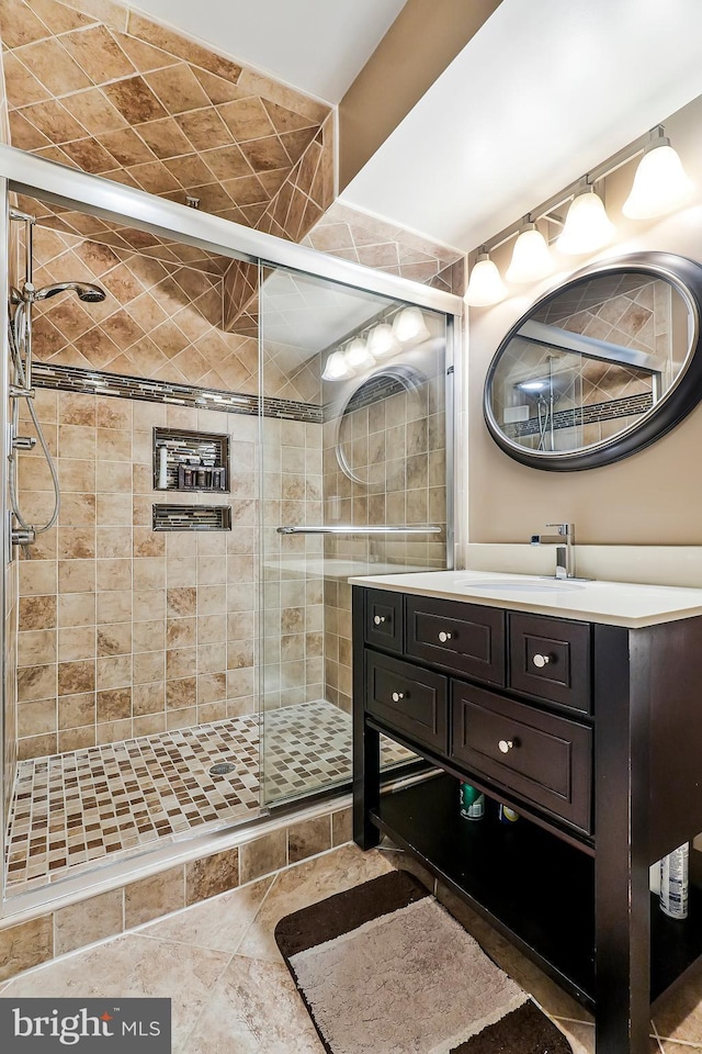 full bath featuring a stall shower and vanity