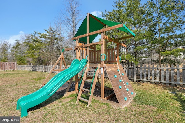 community play area featuring a lawn and a fenced backyard