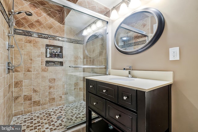 full bathroom featuring a stall shower and vanity