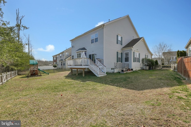 back of house featuring crawl space, a yard, a fenced backyard, and a playground