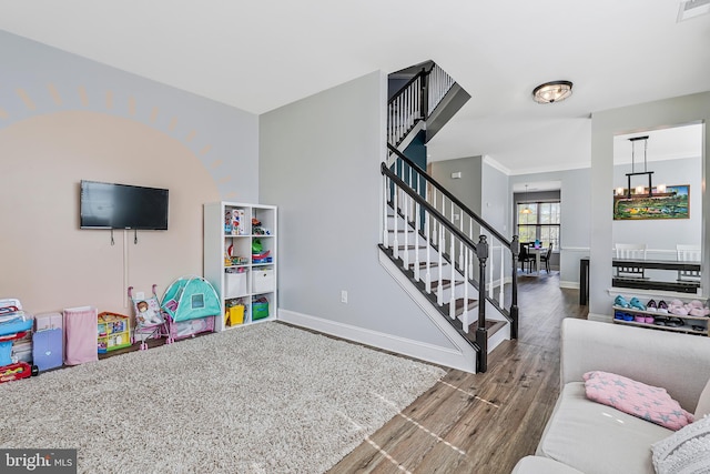 game room with visible vents, baseboards, and wood finished floors