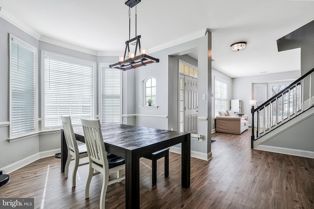 dining area with baseboards, a chandelier, stairs, ornamental molding, and wood finished floors