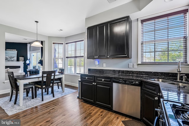 kitchen with black gas stove, dishwasher, dark cabinetry, and a sink