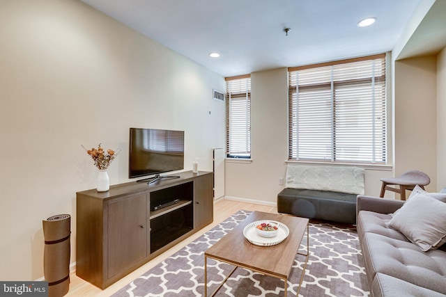 living area featuring visible vents, recessed lighting, baseboards, and light wood-style floors