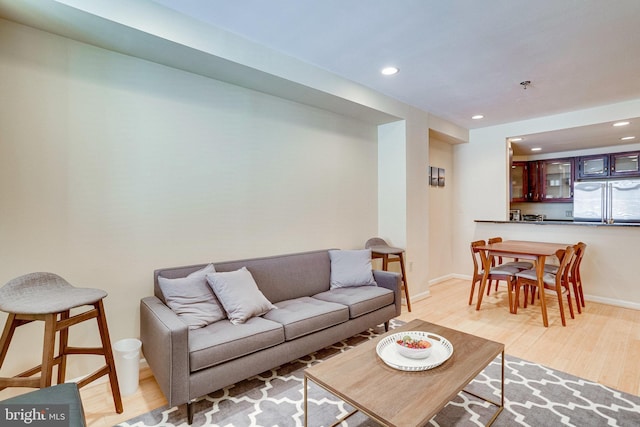 living area featuring recessed lighting, light wood-style floors, and baseboards