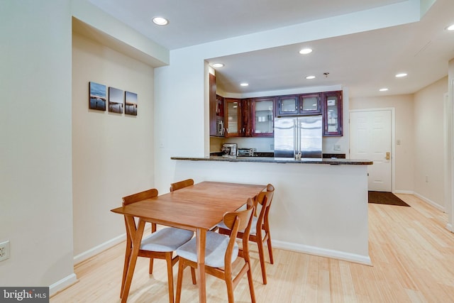 dining area with recessed lighting, baseboards, and light wood finished floors