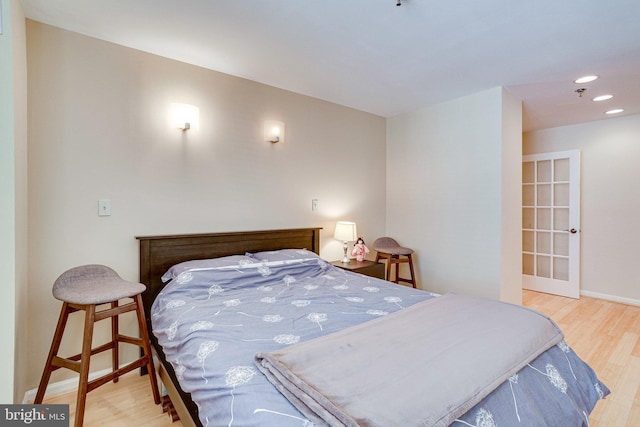 bedroom with recessed lighting, baseboards, and wood finished floors