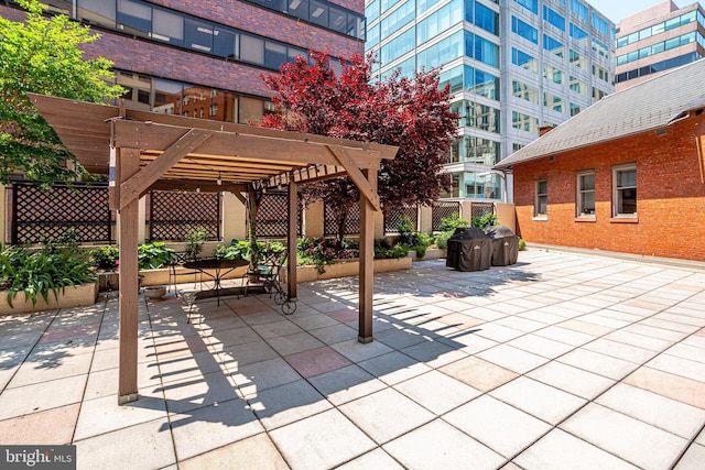 view of patio featuring fence and a pergola