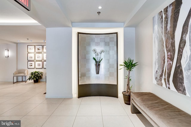 corridor featuring recessed lighting, baseboards, and tile patterned flooring