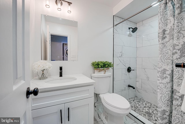 full bathroom with tiled shower, toilet, marble finish floor, vanity, and stacked washing maching and dryer