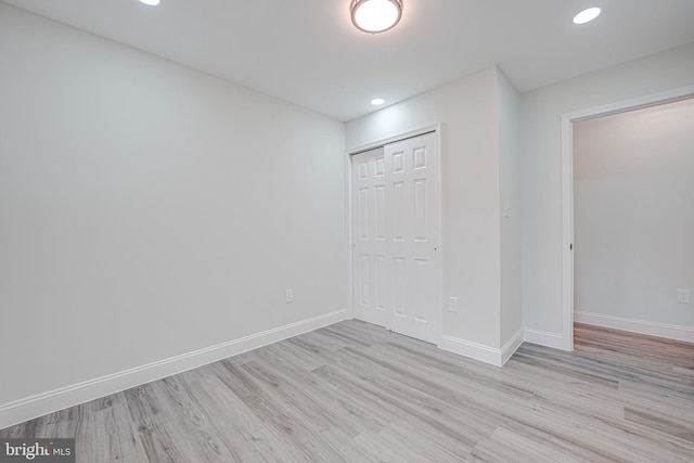 interior space featuring light wood-style floors, a closet, recessed lighting, and baseboards