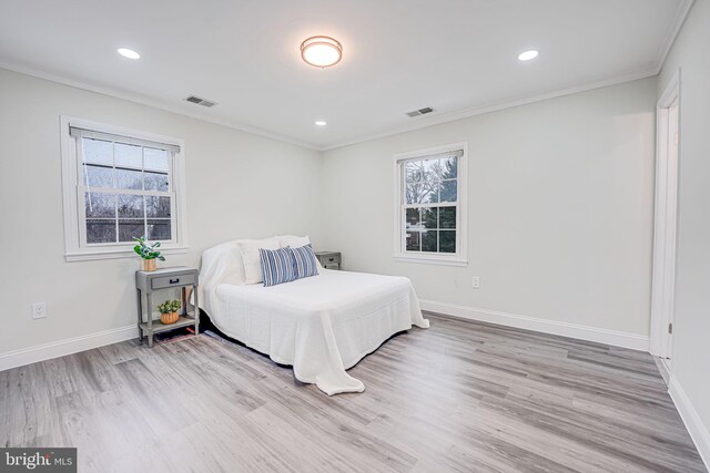 bedroom with visible vents, crown molding, and multiple windows