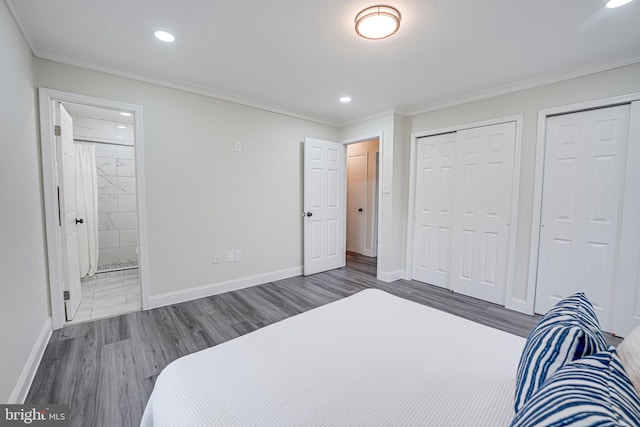 bedroom featuring crown molding, baseboards, and wood finished floors