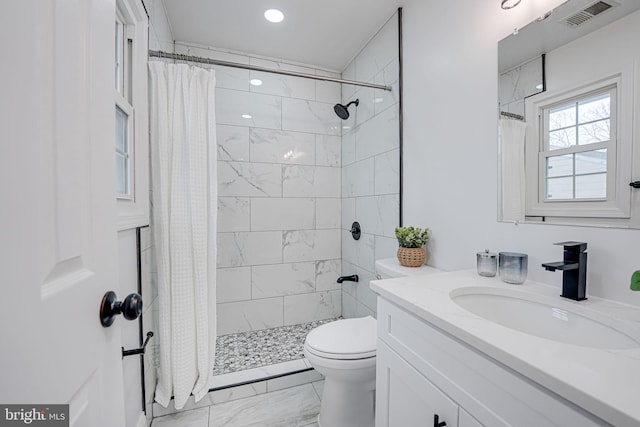 bathroom with visible vents, tiled shower, toilet, marble finish floor, and vanity