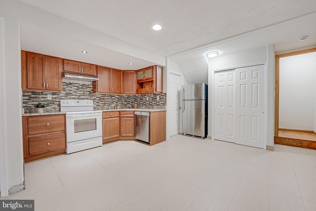 kitchen with tasteful backsplash, brown cabinetry, stainless steel appliances, under cabinet range hood, and open shelves