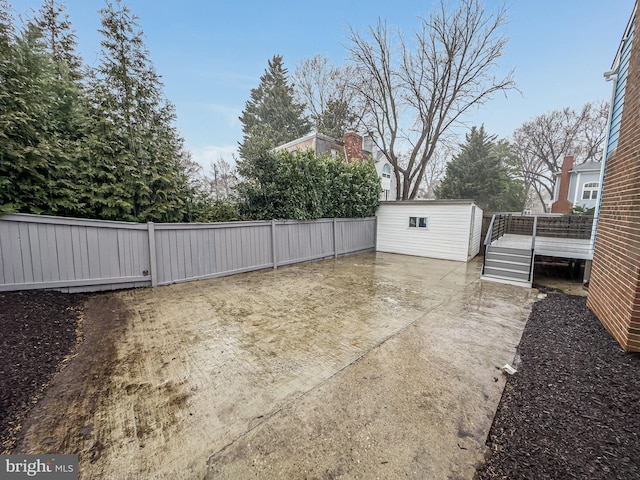 view of patio / terrace with an outdoor structure and a fenced backyard