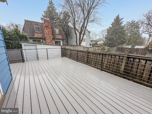 wooden terrace featuring fence