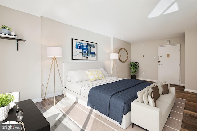 bedroom featuring wood finished floors and baseboards