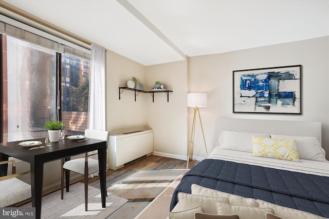 bedroom with baseboards and wood finished floors