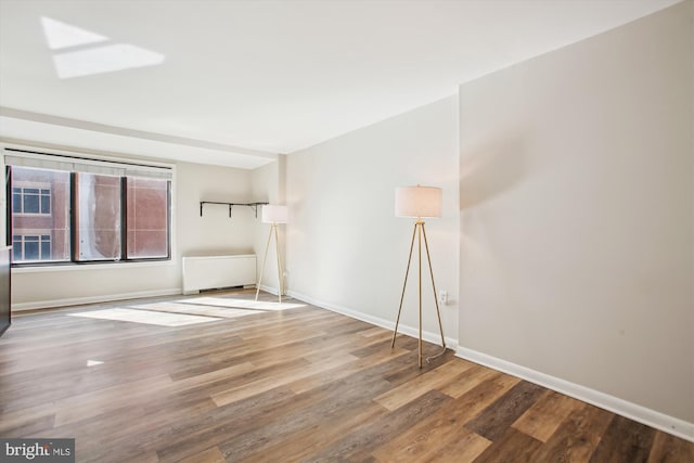 unfurnished bedroom featuring baseboards and wood finished floors