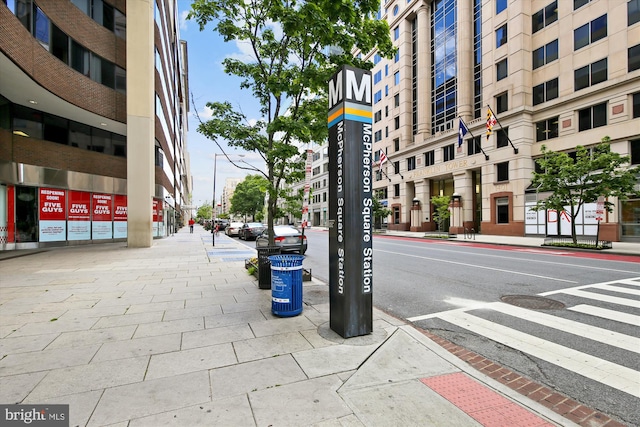 view of road with street lighting, curbs, and sidewalks