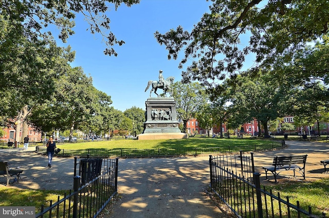 surrounding community with a lawn and fence