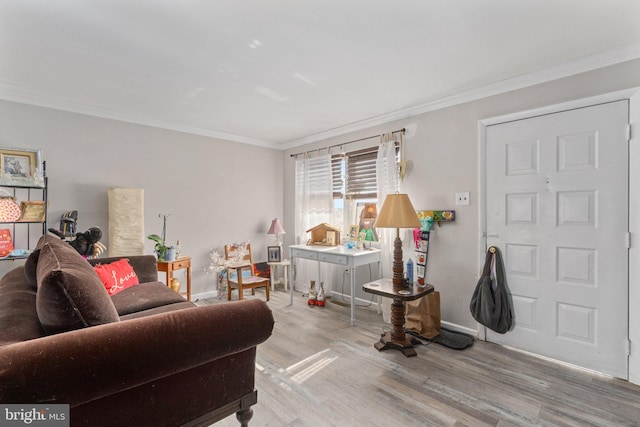 living area with ornamental molding, wood finished floors, and baseboards