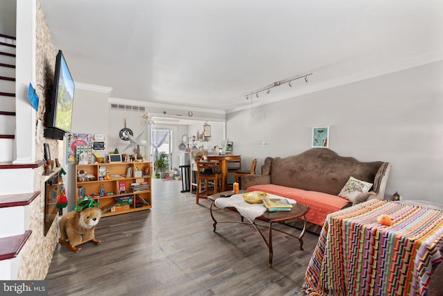 living room with ornamental molding, visible vents, and wood finished floors