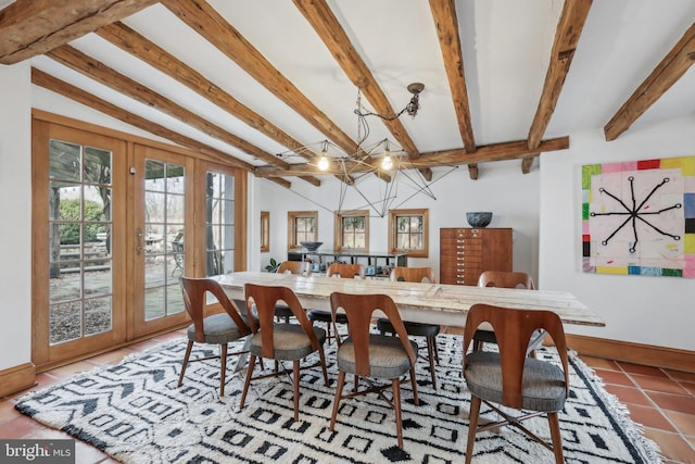 dining area featuring baseboards, lofted ceiling with beams, tile patterned flooring, and an inviting chandelier